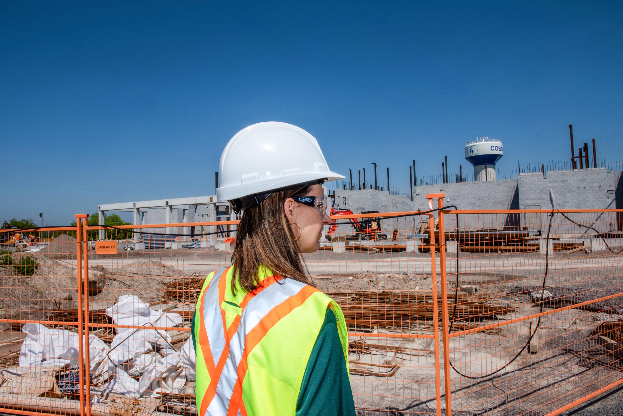 Staff in hard hat looks into construction site